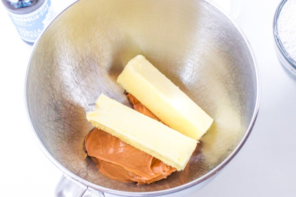 Butter and peanut butter in a mixing bowl before blending together. 