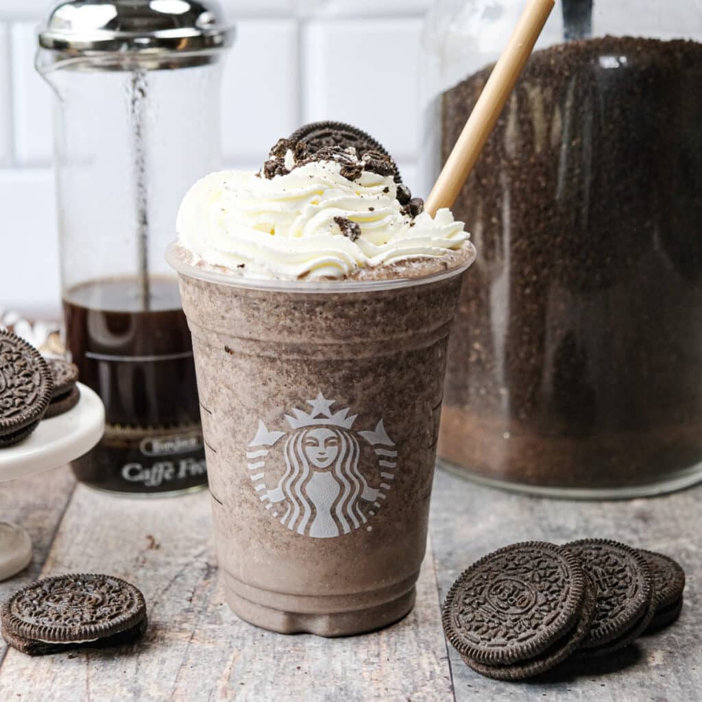 Copycat Starbucks Mocha Cookie Crumble Frappuccino topped with whipped cream and Oreo cookie crumbles.