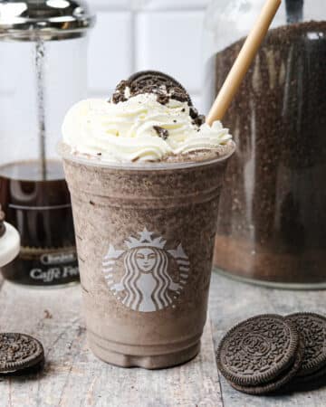 Copycat Starbucks Mocha Cookie Crumble Frappuccino topped with whipped cream and Oreo cookie crumbles.