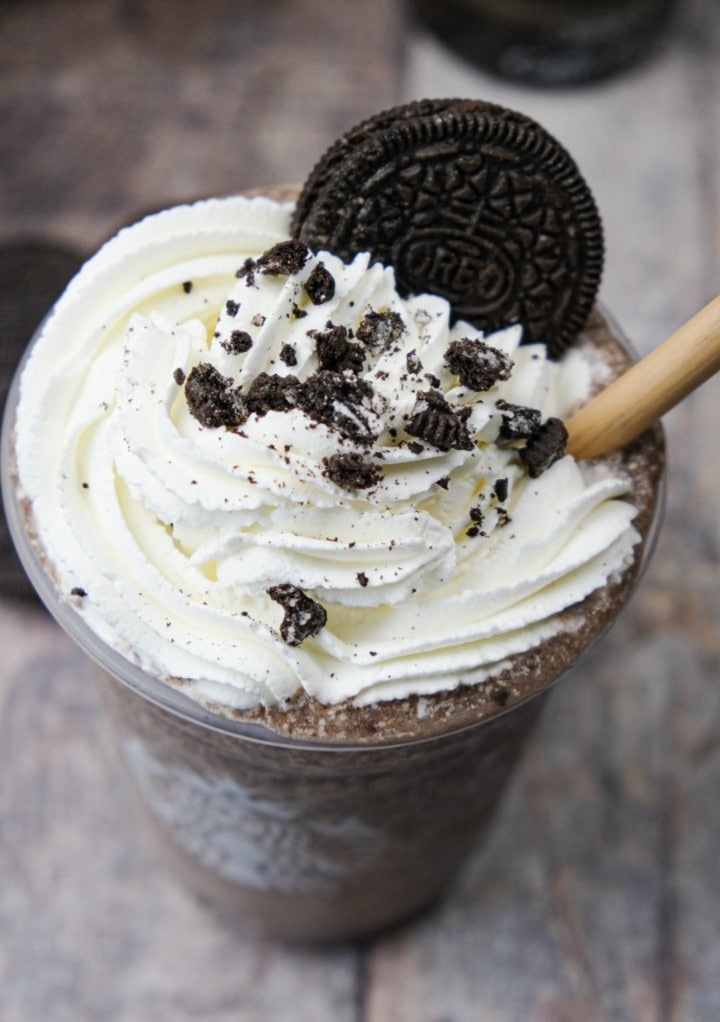 Top view of copycat Starbucks mocha cookie crumble frappuccino topped with whipped cream and garnished with an oreo cookie.