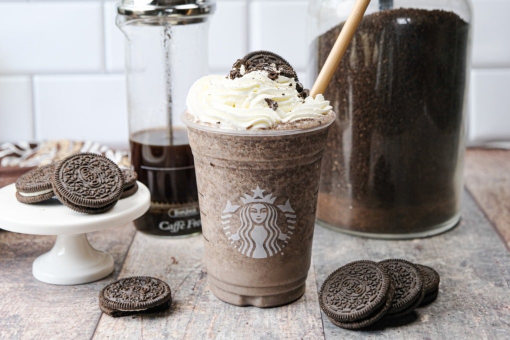 Mocha frappuccino topped with whipped cream and cookie crumbles.