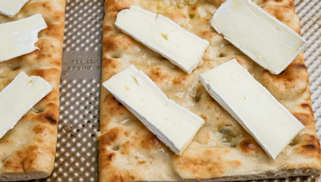 sliced brie cheese on top of pizza crust before baking to melt the cheese. 