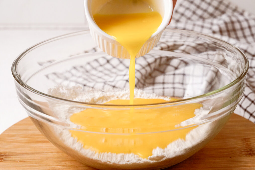 Egg mixture poured over the flour mix to bake a cassrole. 