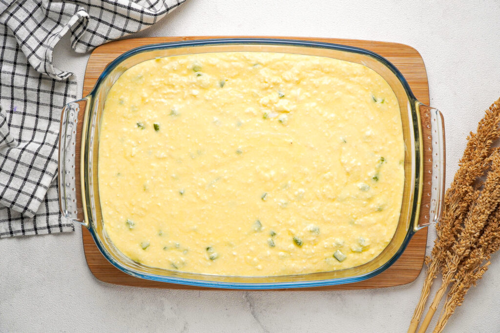Egg casserole in a baking dish before putting in the oven to cook.