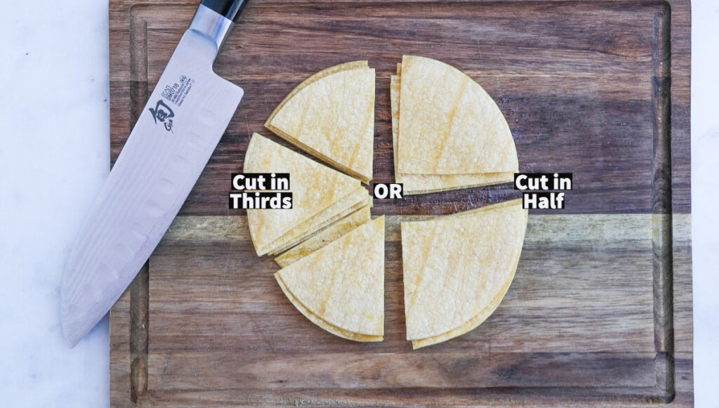 Corn tortillas on a cutting board with half cut in half and the other half cut in thirds. 