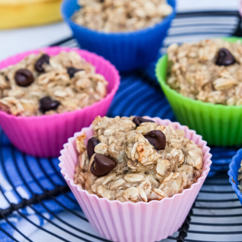 Oatmeal cups in silicone baking cups cooling on a baking rack.