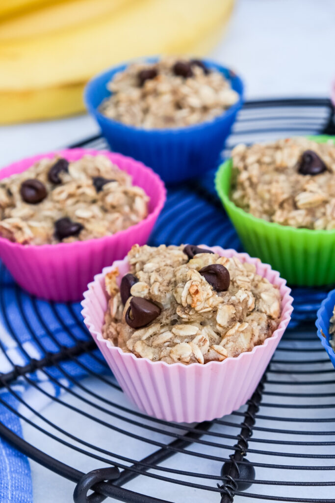 Oatmeal cups in silicone baking cups cooling on a baking rack.