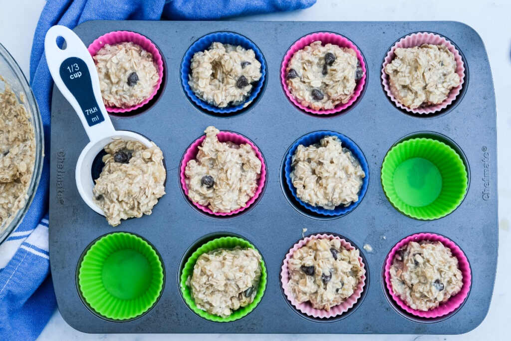 Oatmeal cups with batter in silicon baking liners before baking. 