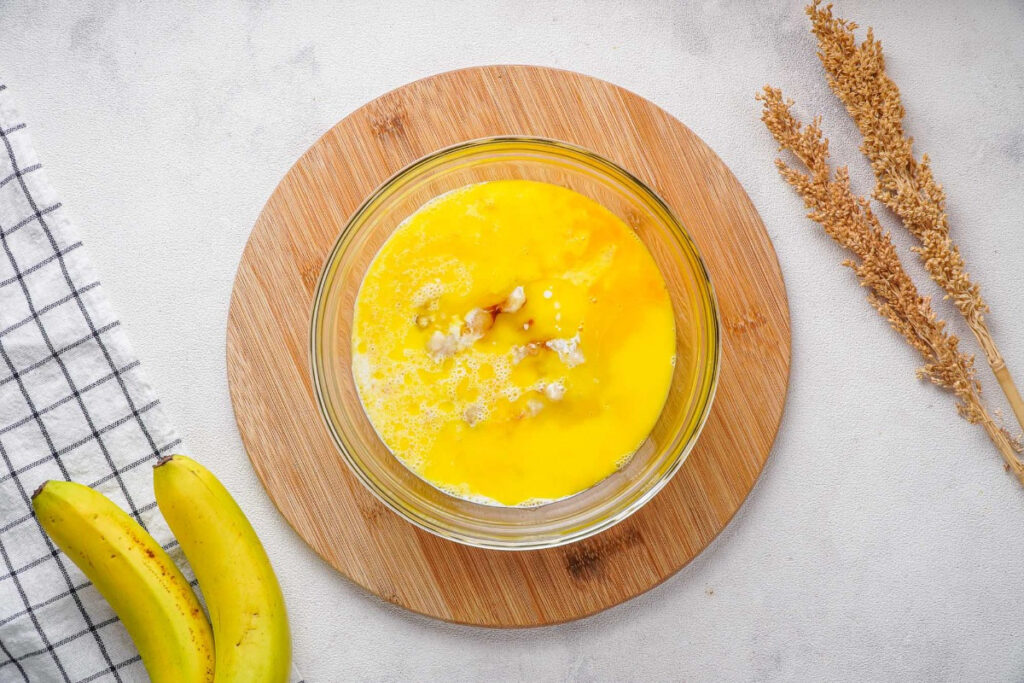 Wet ingredients in a mixing bowl for pancake recipe. 