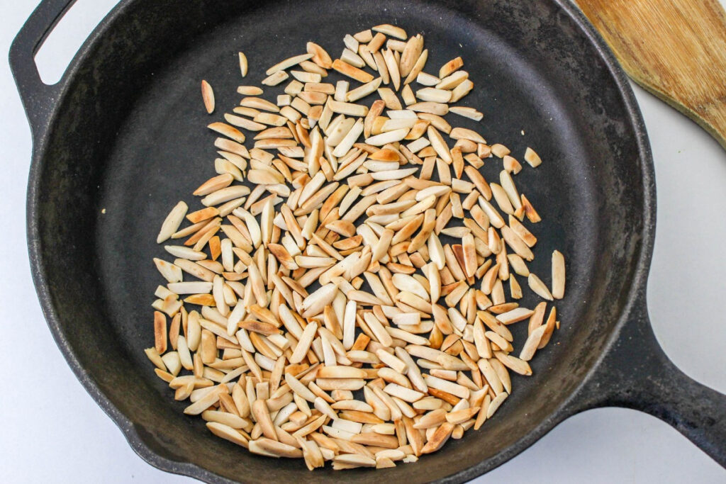 Toasted almonds in an iron skillet. 