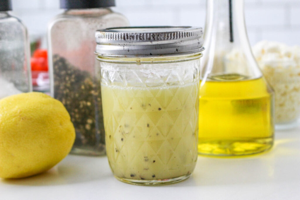 Homemade lemon salad dressing in a small mason jar. 