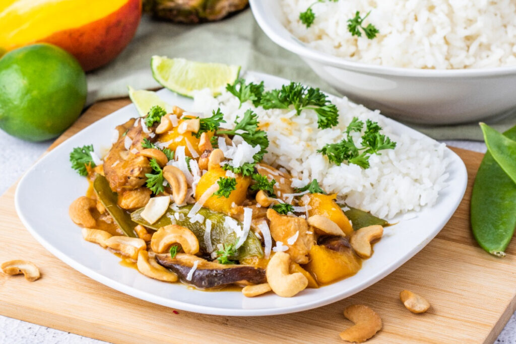 Chicken dish with rice on a white dinner plate. 