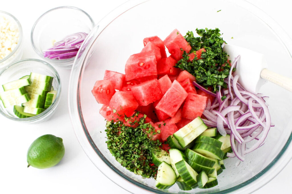 Watermelon salad Ingredient in a large clear mixing bowl. 