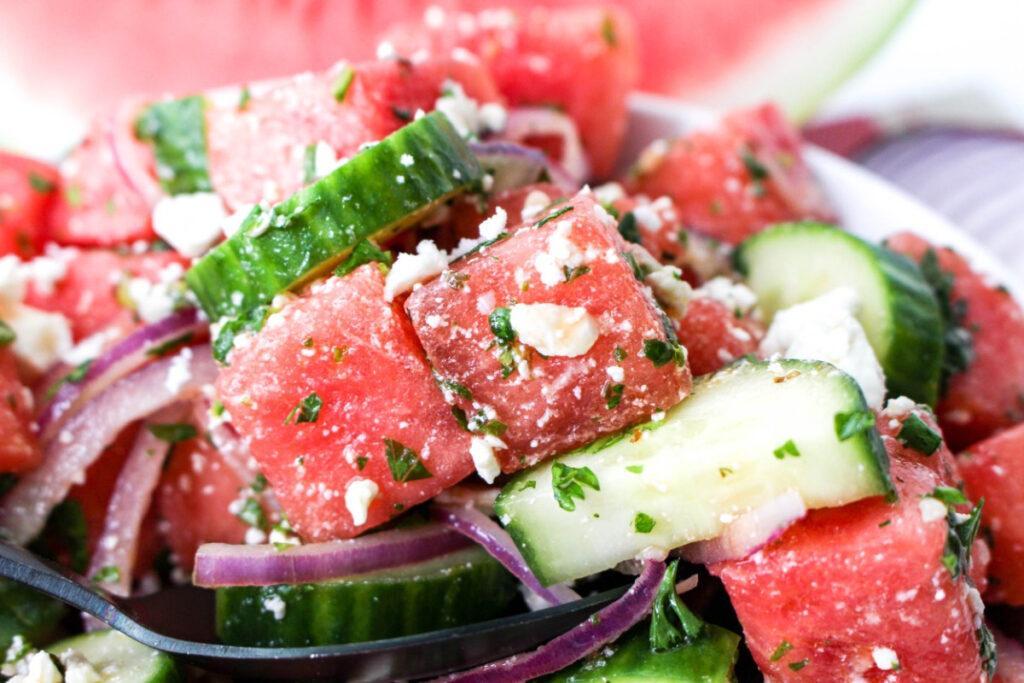 Close view of a spoonful of watermelon feta mint salad.