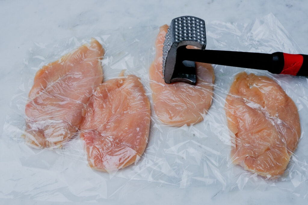 Chicken breasts pounded with a meat mallet. 