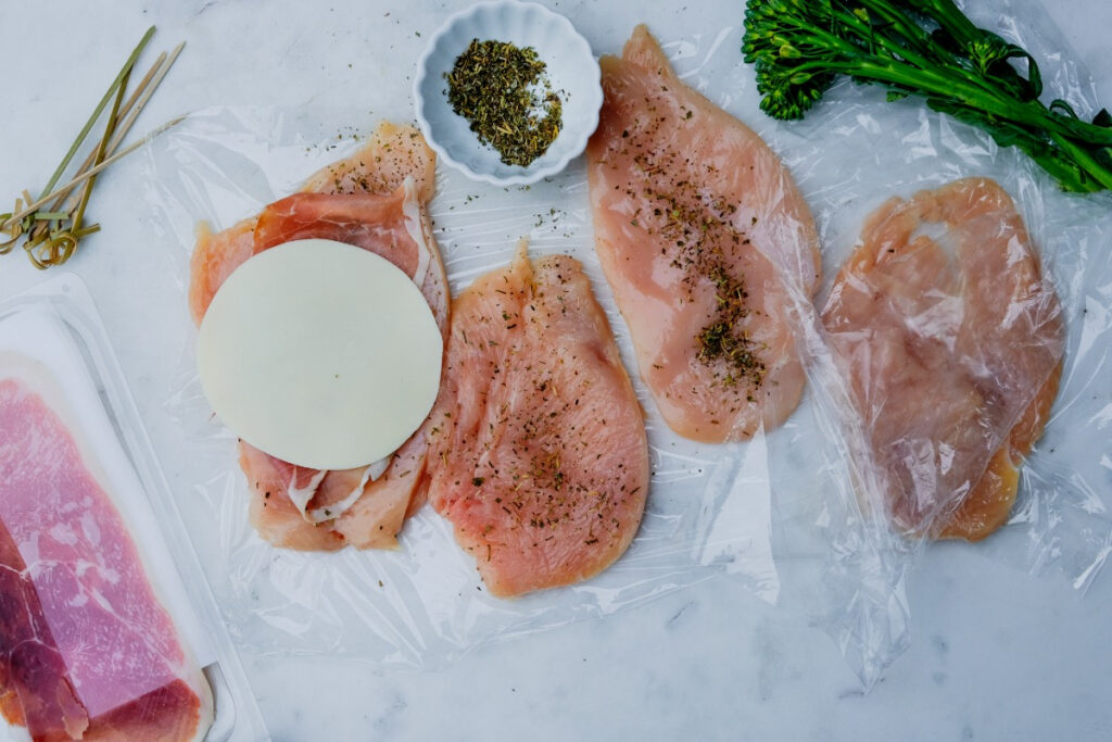 Chicken breasts seasoned and topped with cheese. 