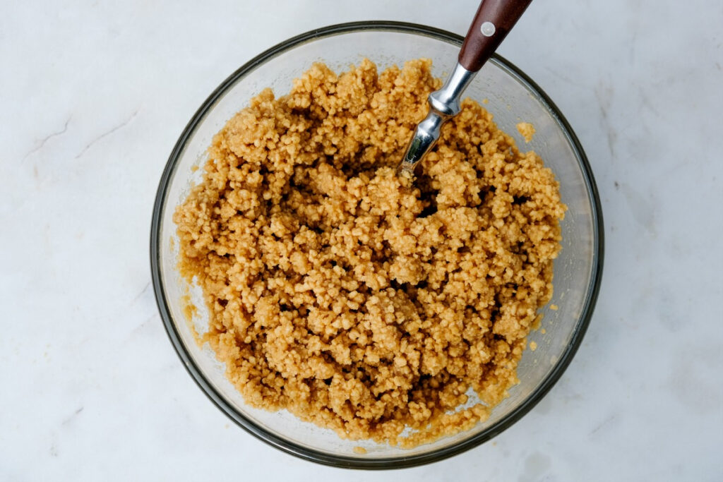 Crushed keto cereal with butter in a mixing bowl 