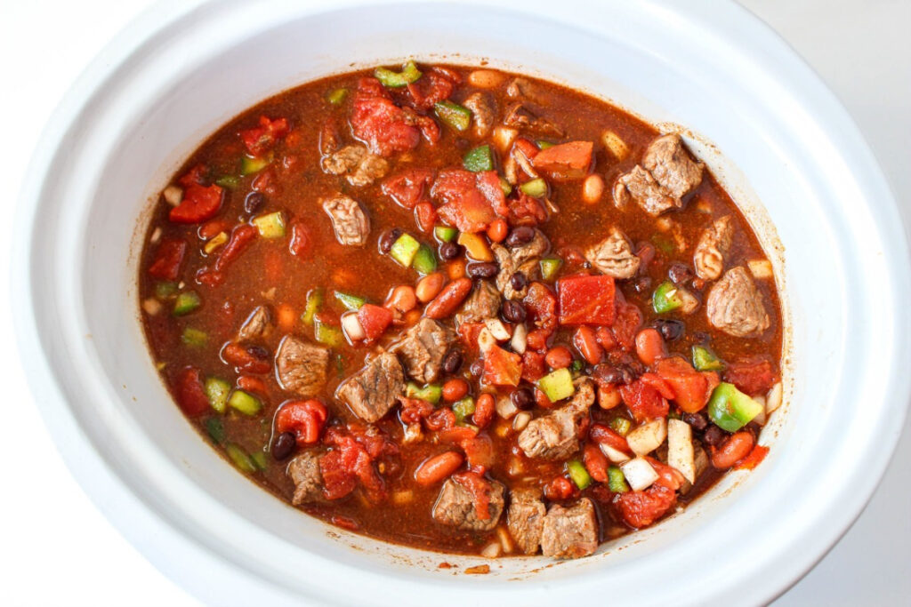 Brisket chili in a white slow cooker. 