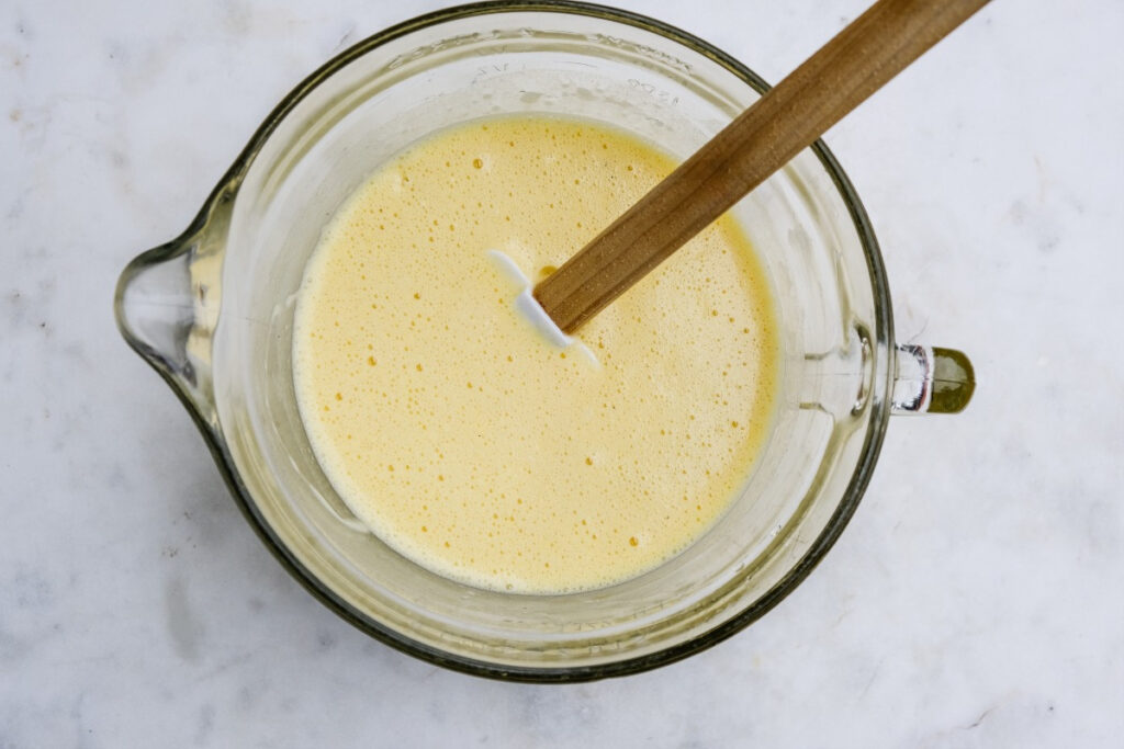 Egg mix in a clear mixing bowl. 