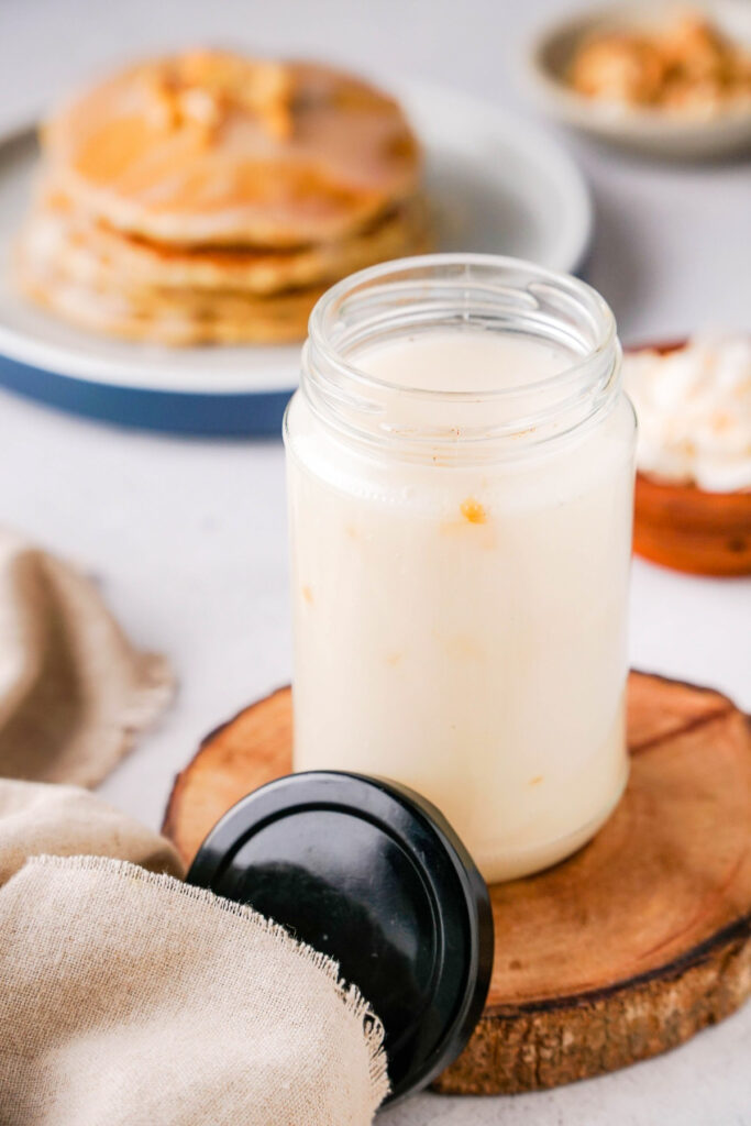 Coconut syrup in a clear jar with a black lid. 
