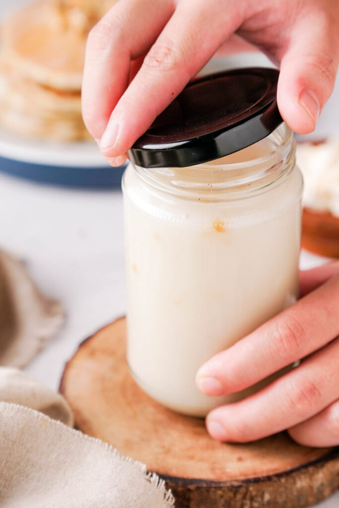 Homemade syrup in a clear jar with a black lid. 