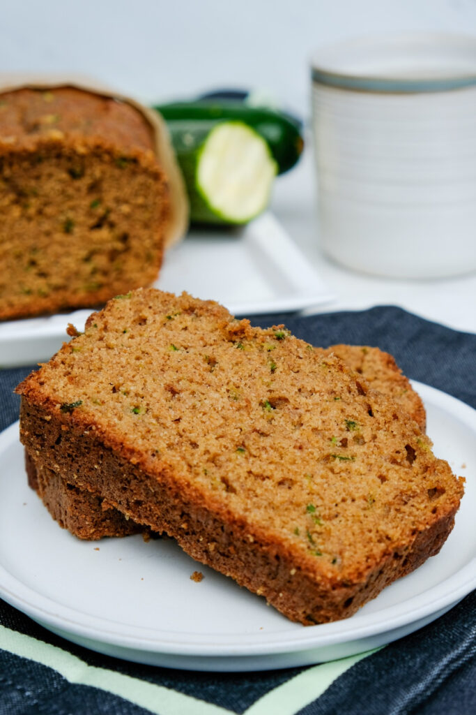 Slice of zucchini bread on a small white plate. 