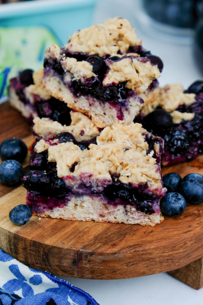 Blueberry oatmeal bars on a brown plate. 