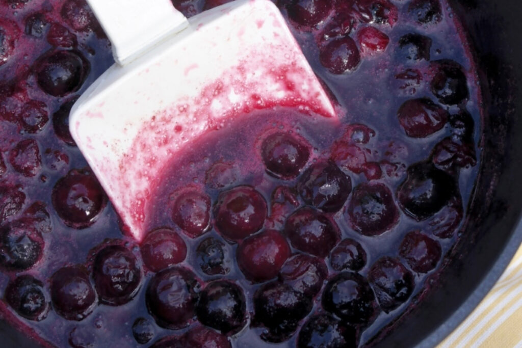 Homemade blueberry sauce is a small saucepan. 