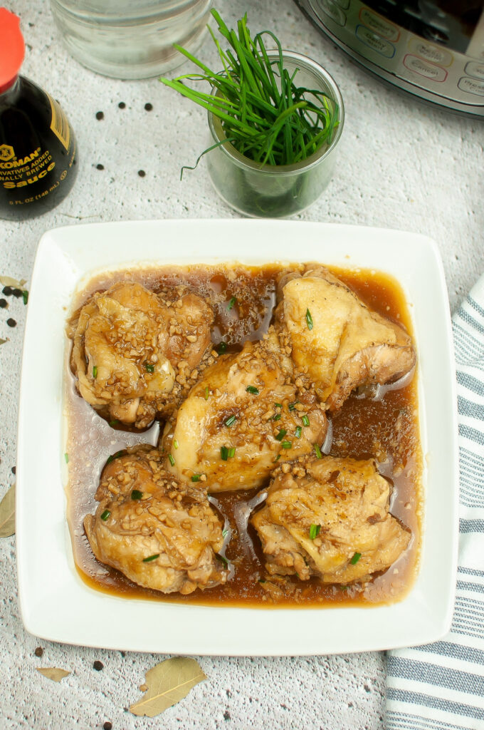 Top view of chicken adobo on a serving plate. 