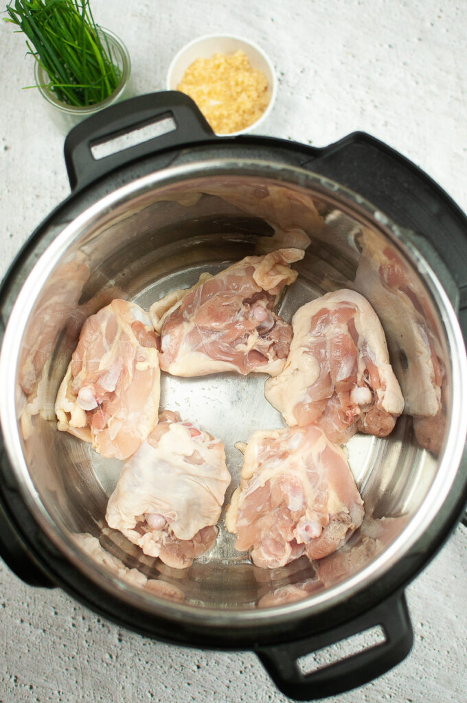Sautéed chicken in the center insert of an Instant Pot. 