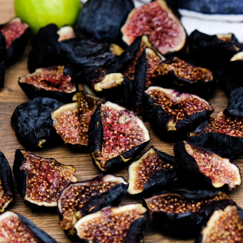 Dried figs on a brown table.