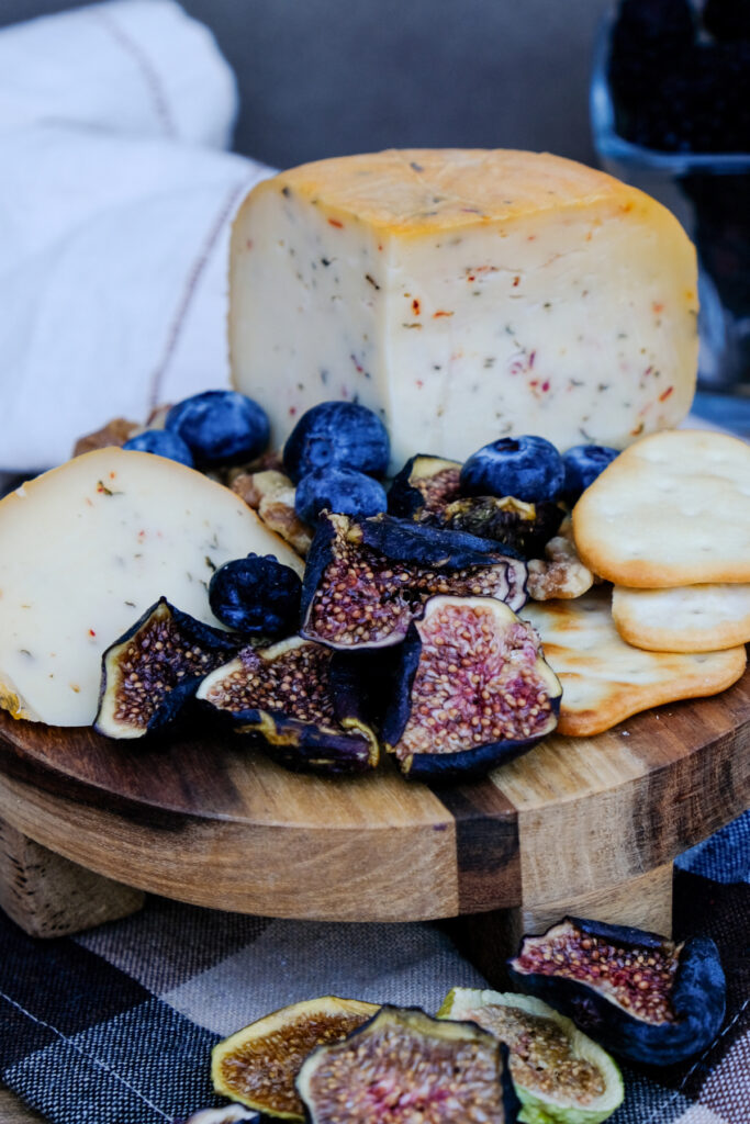 Cheese board with dried figs, blueberries, and walnuts. 