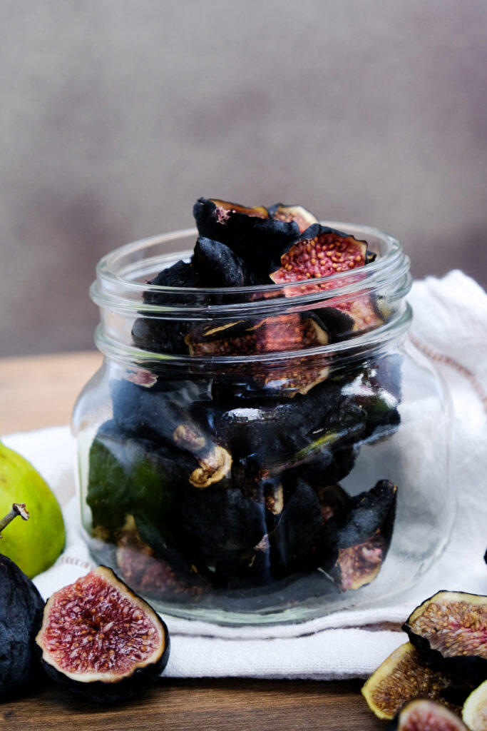 After drying figs in a dehydrator they are cooled and placed in a glass jar.  