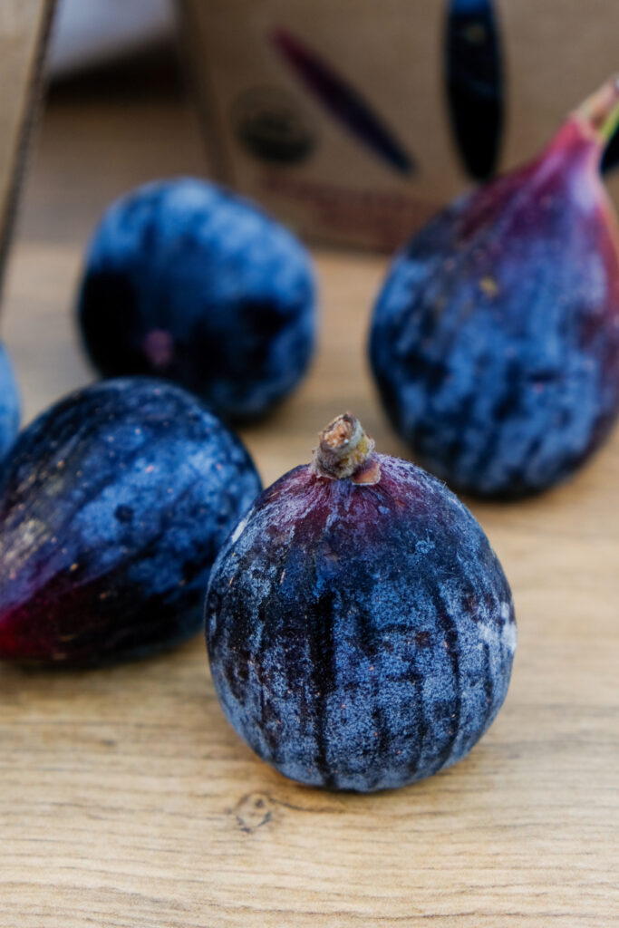 Fresh California Mission Black fig on a brown table. 