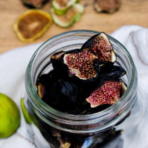 Dried figs in a clear glass jar.