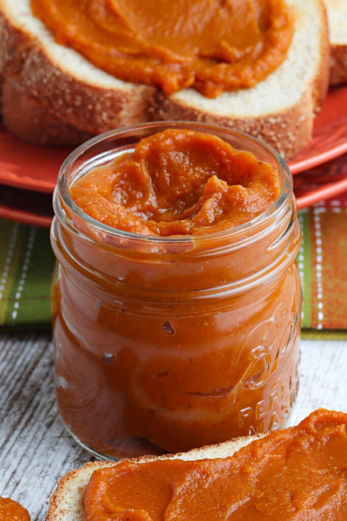 Homemade pumpkin butter in a clear glass mason jar. 