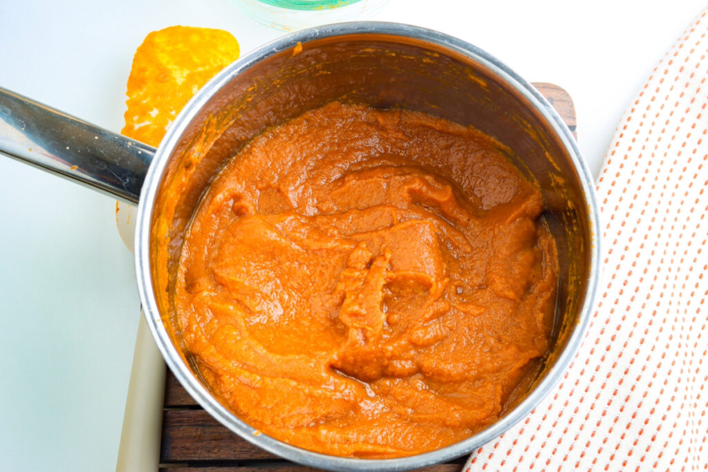 Thick cooked pumpkin butter in a silver saucepan. 