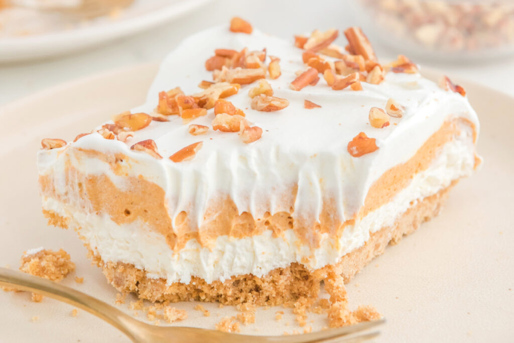 Pumpkin lush dessert on a white serving plate. 