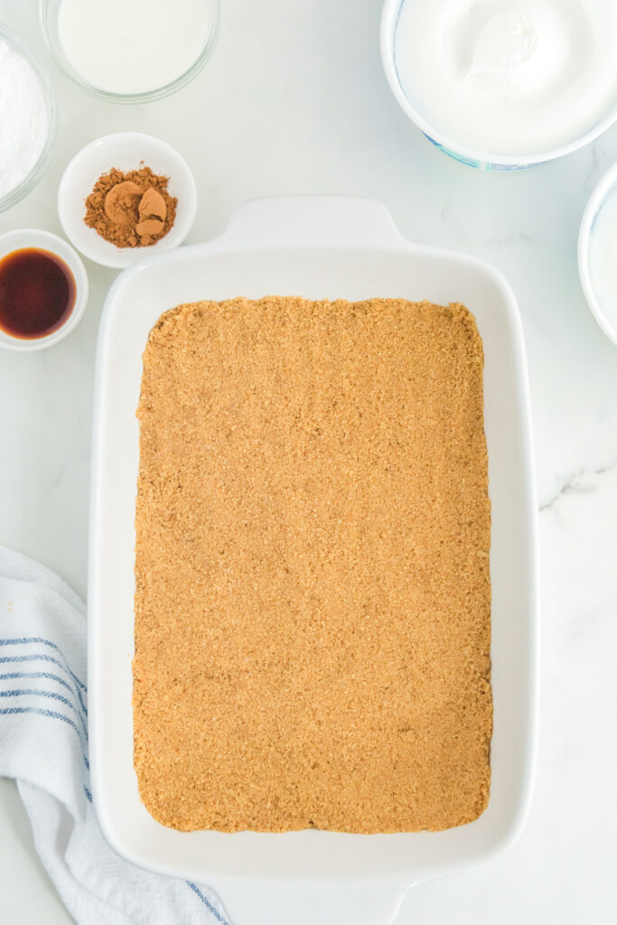 Graham cracker crust on the bottom of a 9" x 13" baking pan.