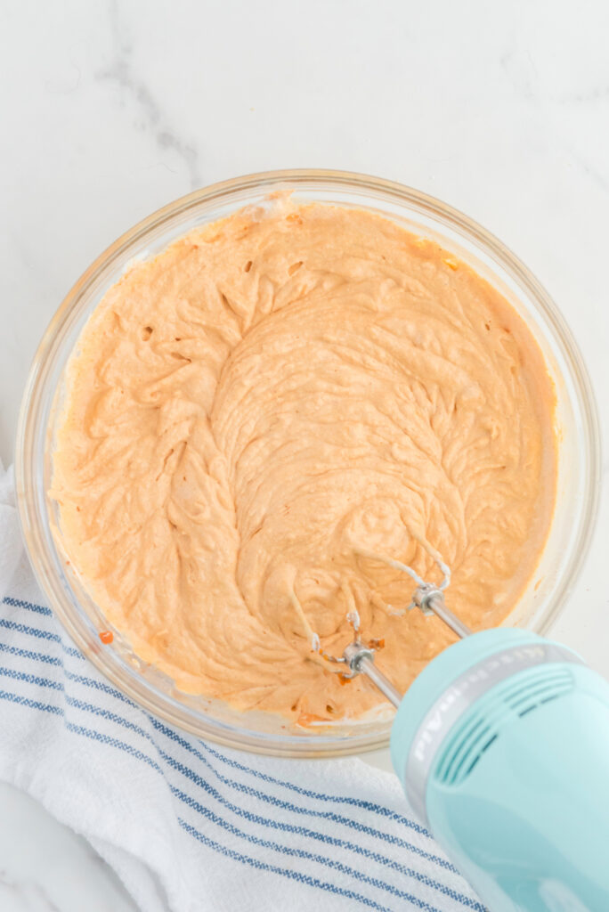 Pumpkin mix for layered dessert in a mixing bowl. 