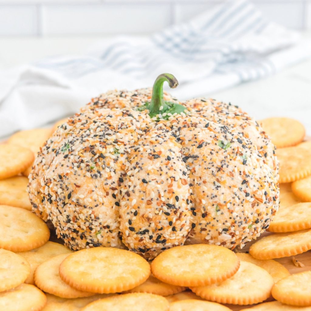 Pumpkin shaped cheese ball with everything bagel seasoning.