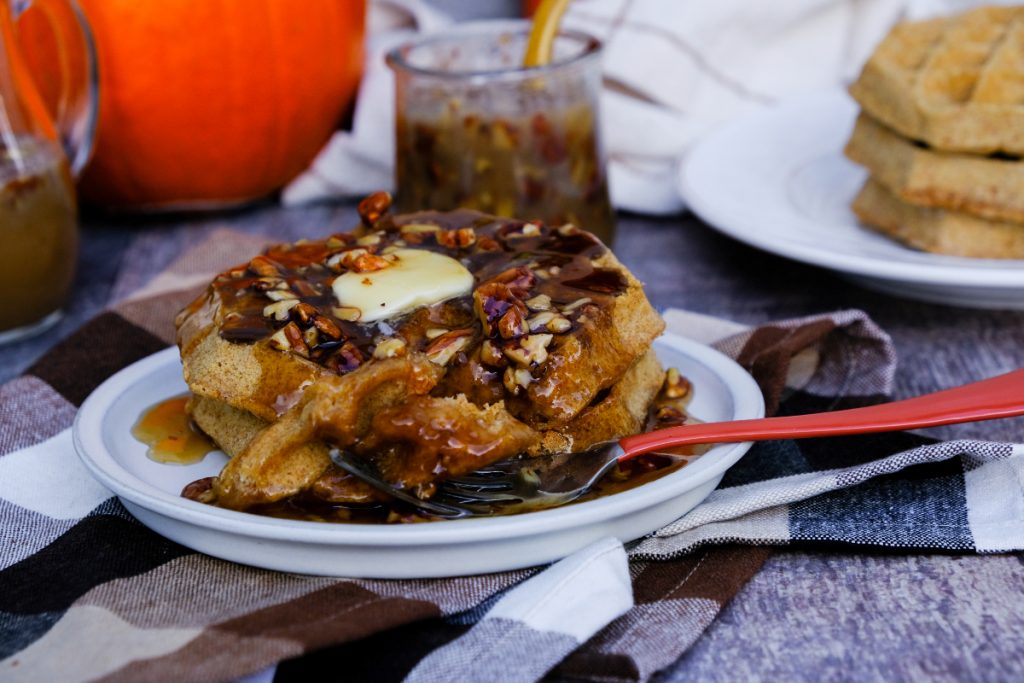 Waffles topped with maple syrup.