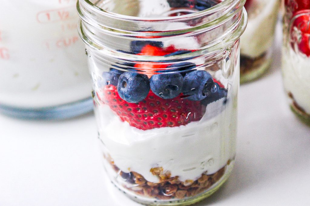 Mason jar with granola and Greek yogurt. 