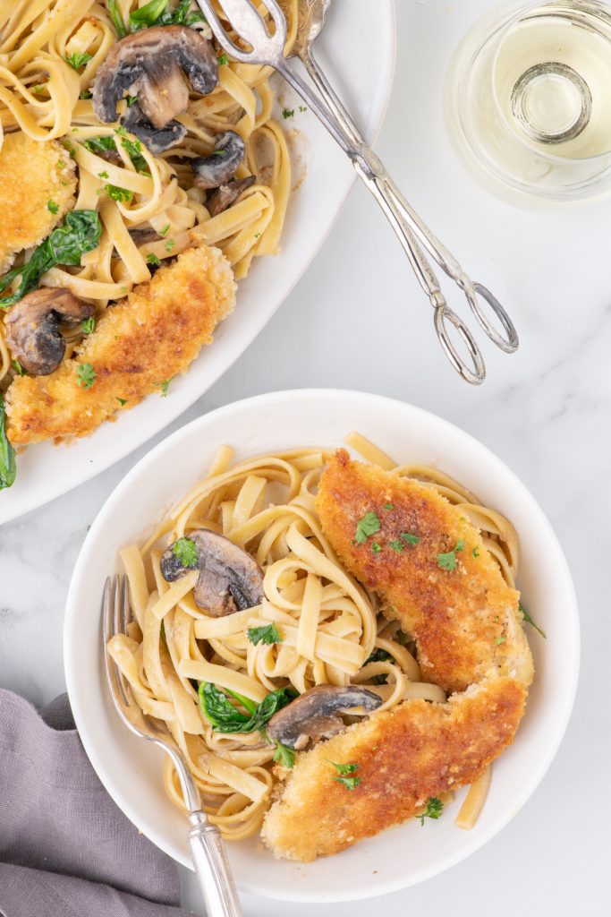 Top view of chicken dinner with pasta. 