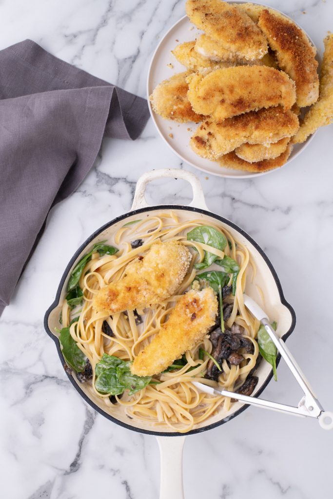 Complete chicken marsala dish assembled in a skillet with the sauce before serving. 