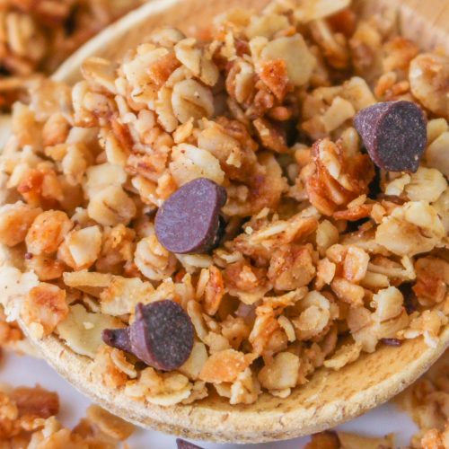 A wooden spoon filled with homemade granola.