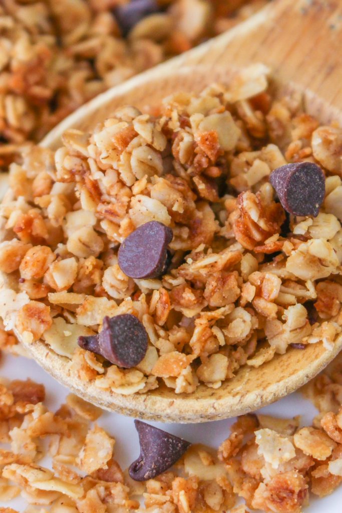 A wooden spoon filled with homemade granola.