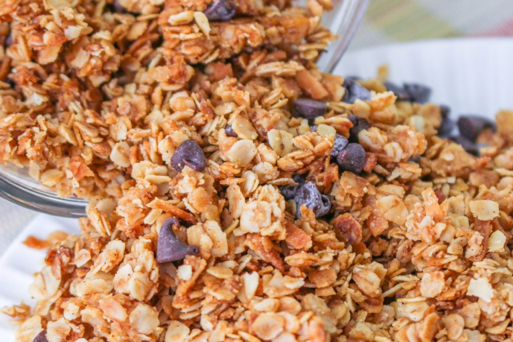 Homemade granola made with old-fashioned oats on a white plate.