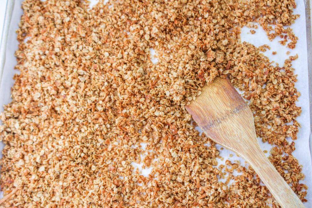 Toasted granola on a baking sheet lined with parchment paper.