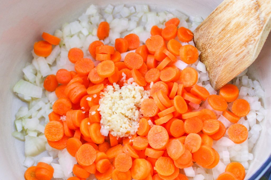 Sautéd diced onion and carrots in a Dutch oven.